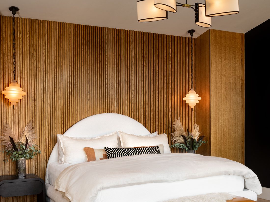 Bedroom interior with a patterned wallpaper feature wall